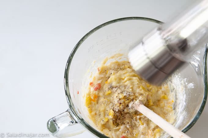 adding ground pepper to squash patty batter