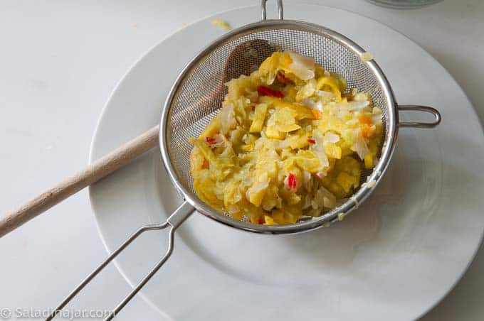 straining excess moisture from cooked squash.