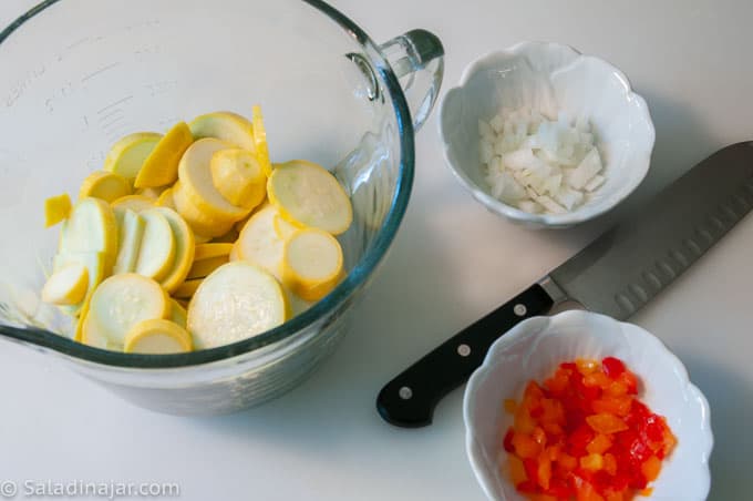 raw yellow squash, onions, and red peppers