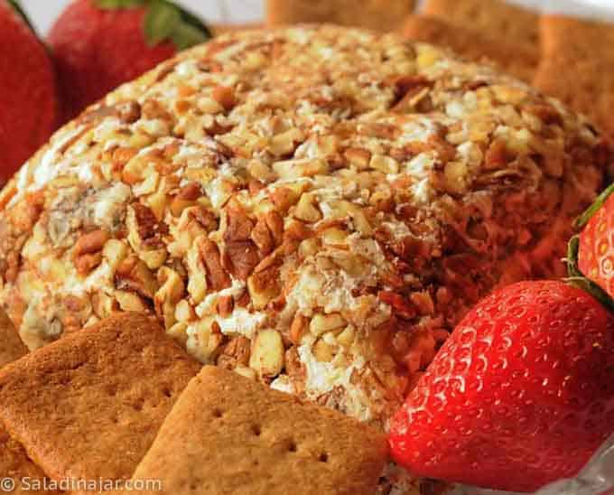 closeup Date Cheese ball-decorated with strawberries and served with homemade graham crackers.