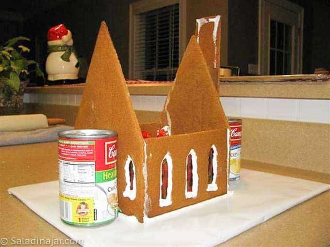house without the roof held in place with soup cans.