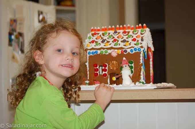 granddaughter with her gingerbread house (a simple one)