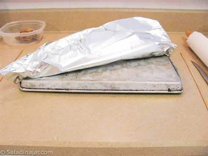 covering cookie sheet with foil