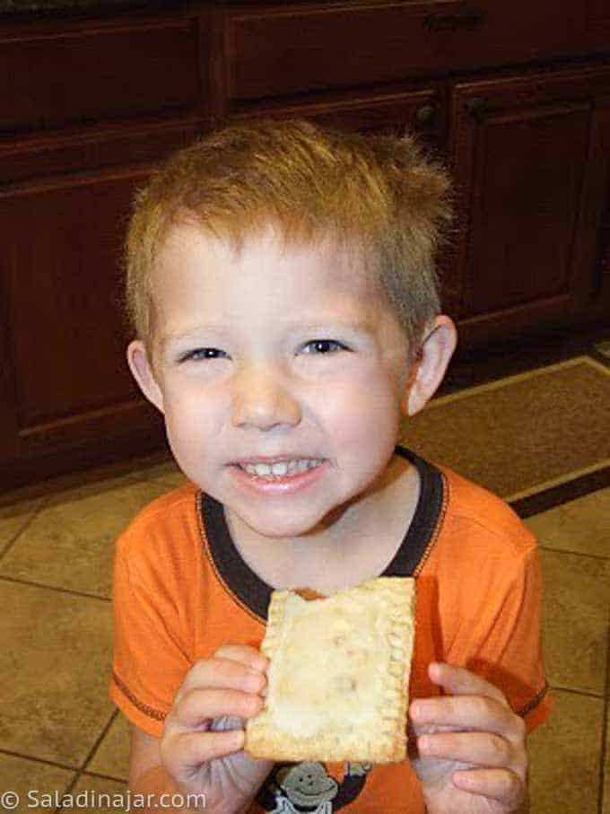 small child happily eating a pop tart