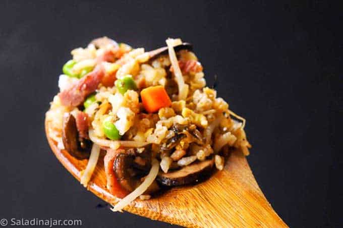 ham fried rice on wooden spoon