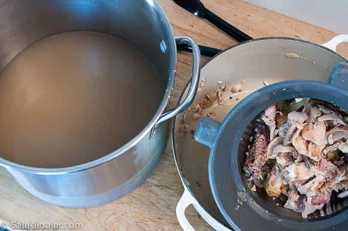 using a fine mesh sieve to strain chickn broth