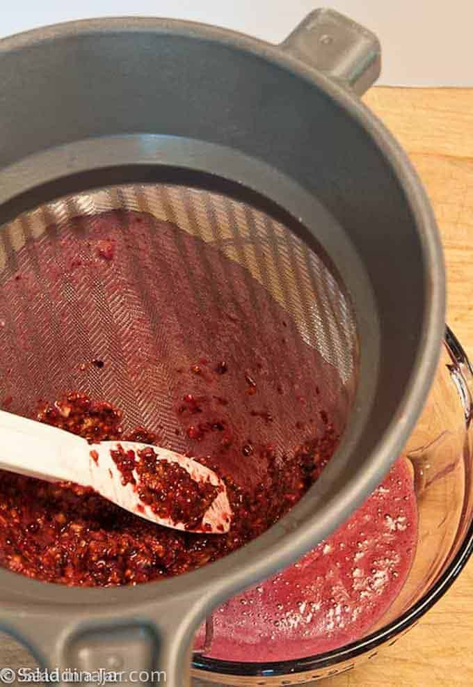 straining seeds out of berries