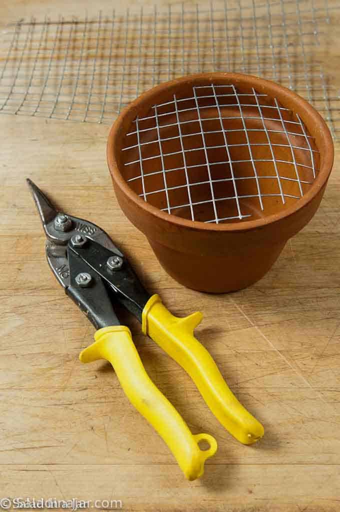 wire cutter, wire mesh and a flower pot for making a table-top marshmallow roaster