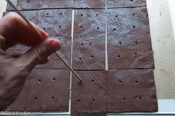 poking holes in crackers with a wooden kbob stick