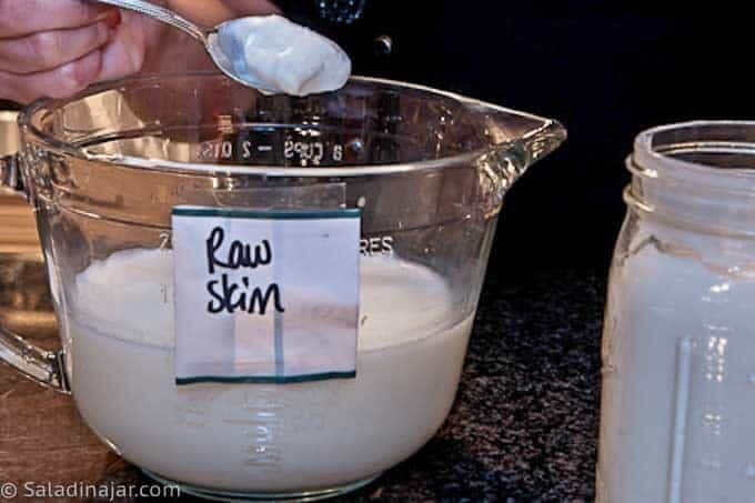 Adding the starter to cooled raw milk.