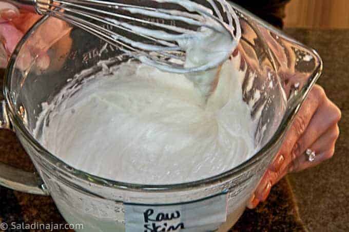 Whisking strained yogurt to make Greek yogurt.