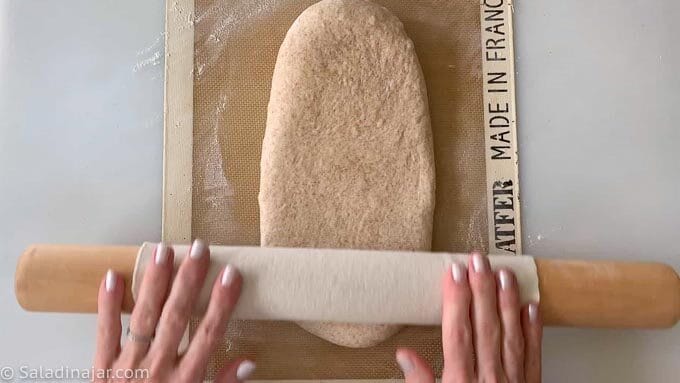 Rolling dough into a rectangle.