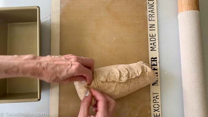After rolling up the dough, pinch the seams and ends shut.