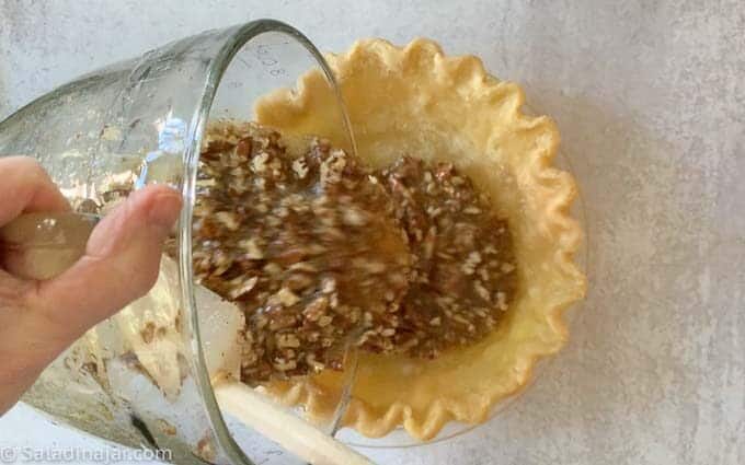 pouring filling into pie crust