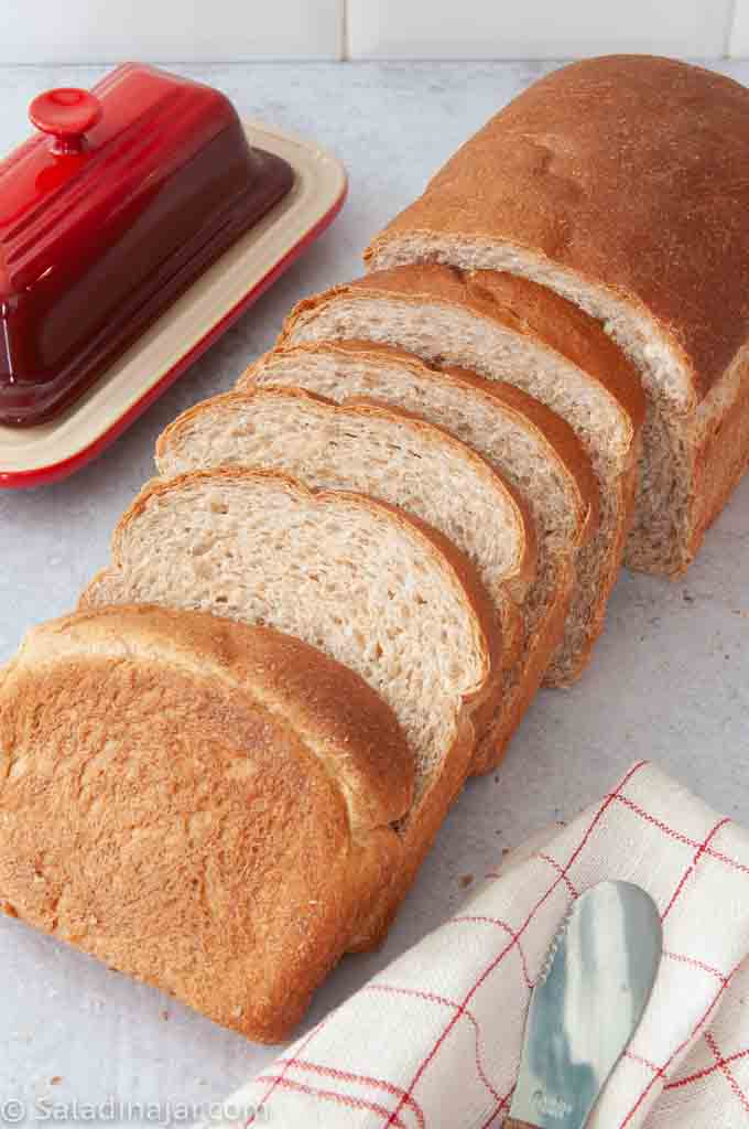 sliced loaf of honey wheat bread machine bread