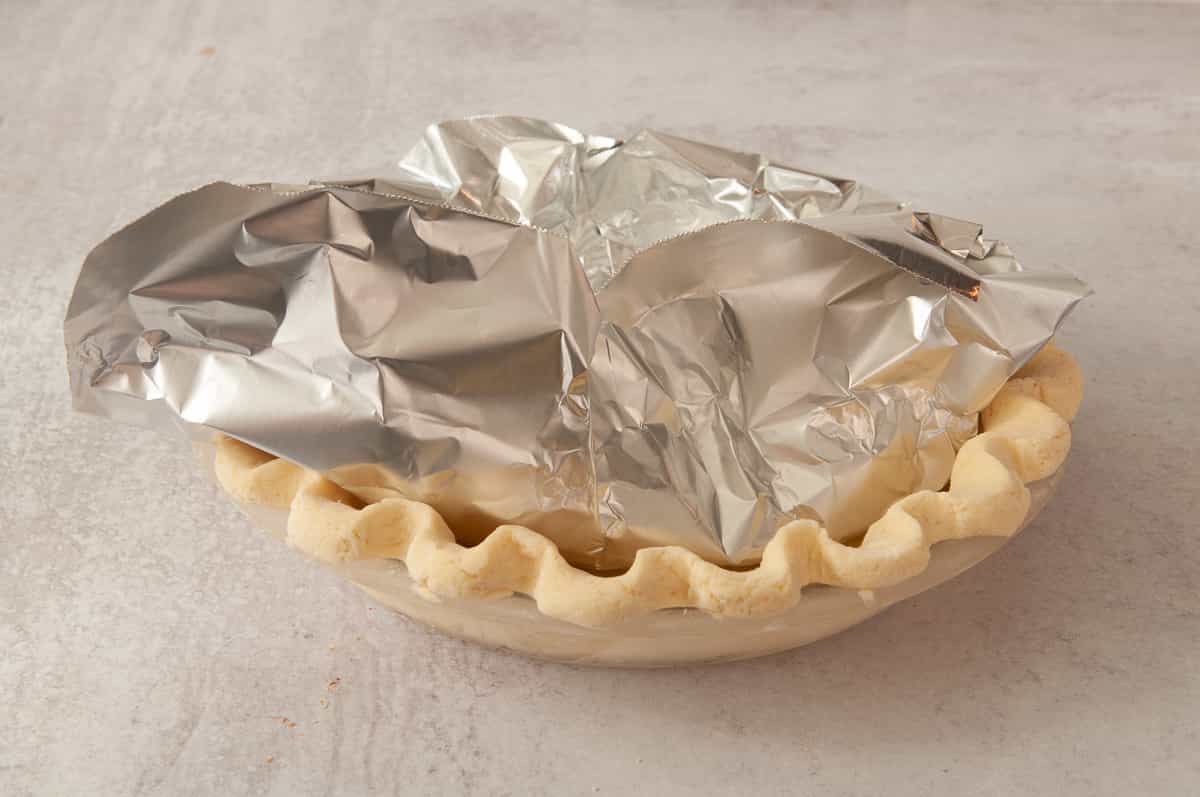 lining the pie crust with foil.