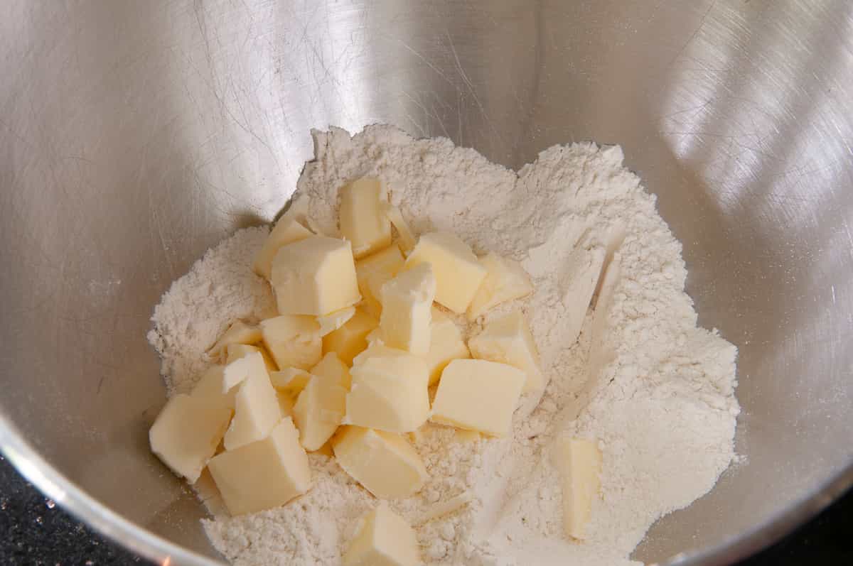 adding butter to the flour.