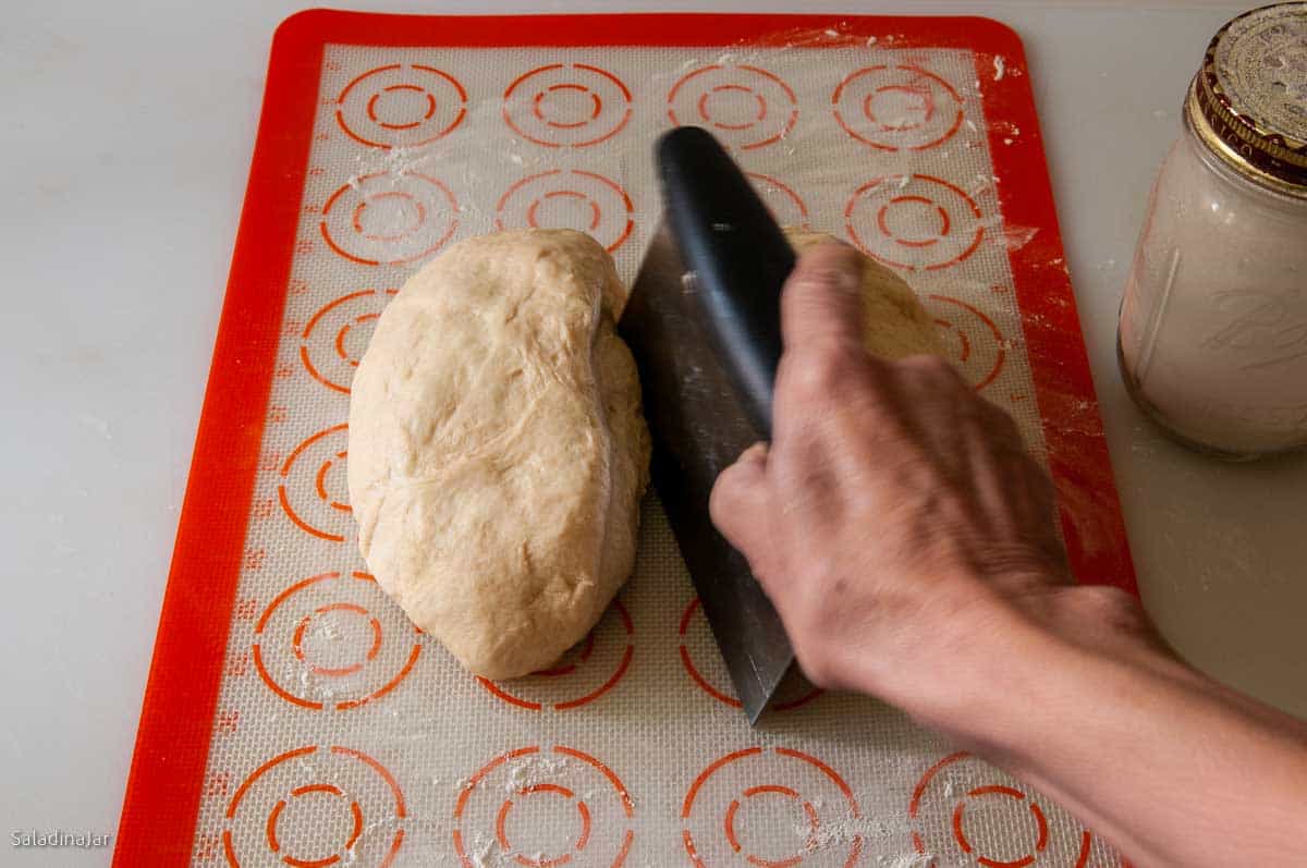 dividing the dough into two equal parts.