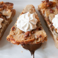 slices of apple pie with whipped cream on top.