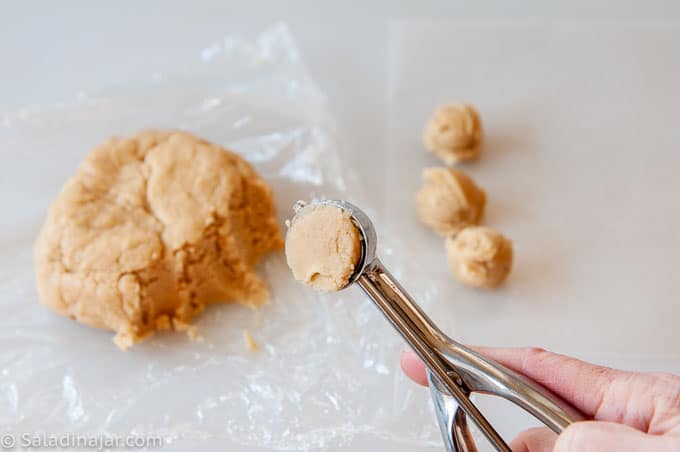 portioning cookie dough with a spring-loaded ice cream scoop