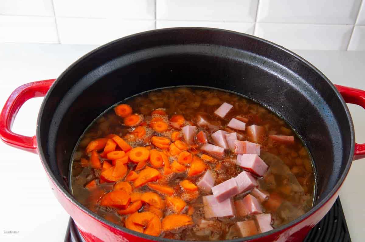 Add sliced carrots, and ham cubes to the stew.