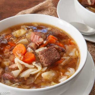 two bowls of hearty beef and ham stew