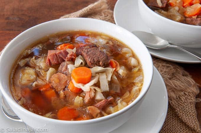 two bowls of hearty beef and ham stew