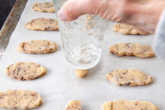 using a glass to flatten cookies