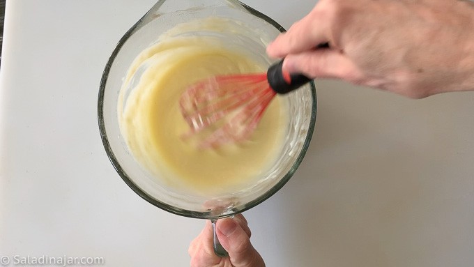 whisking pudding as it cooks