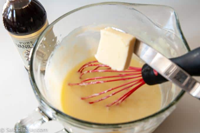 adding butter and vanilla to cooked cream
