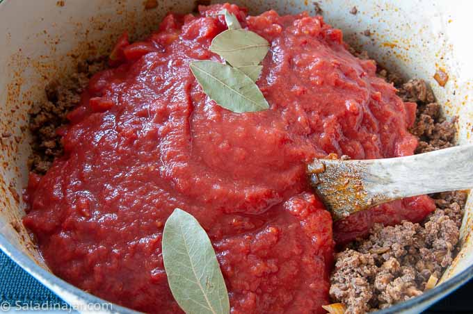 adding tomatoes and bay leaf