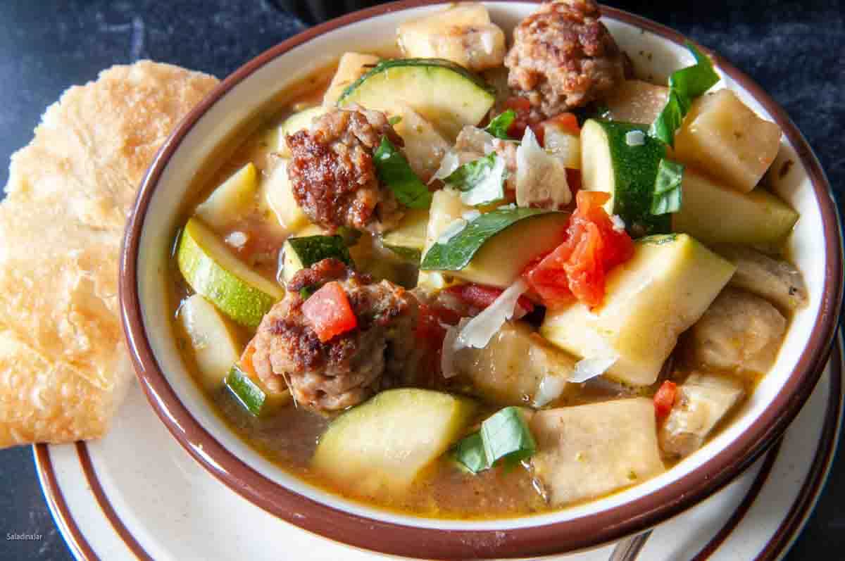 Meatball Ratatouille Soup with fresh basil and cheese for garnish