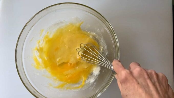 whisking butter in to eggs and sugar