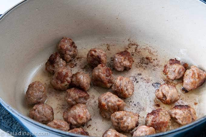 browning meatballs in a Dutch oven