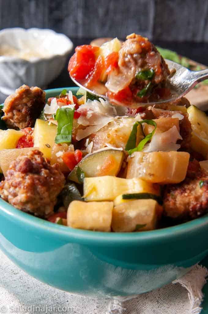 close-up of meatball ratatouille soup with a spoon