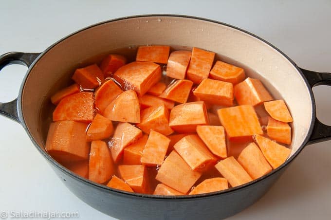 cooking sweet potatoes and white potatoes on the stove