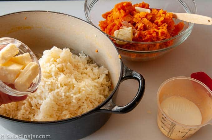 adding butter and warm milk to potatoes