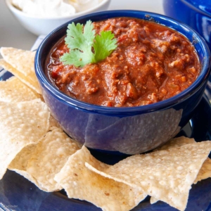 bowl of chocolate chili with tortilla chips on the side