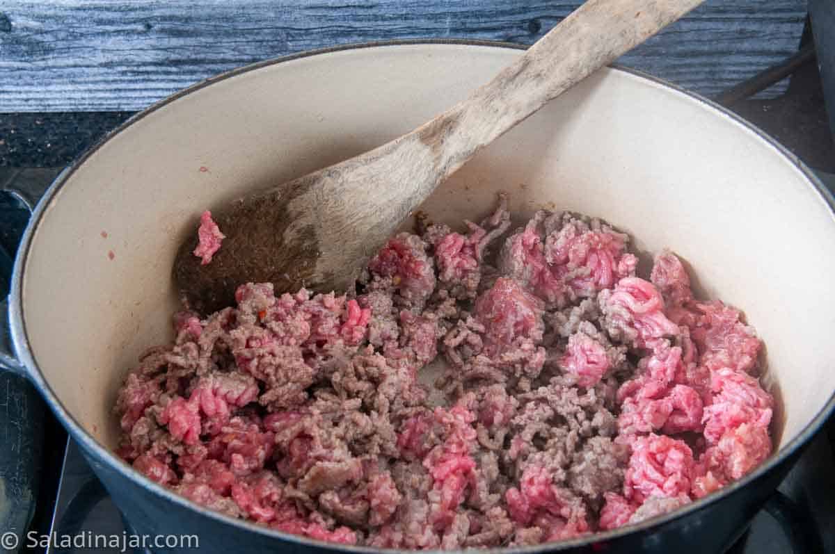 Browning ground beef in a large pot.