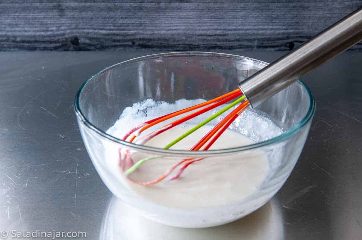 whisking yogurt starter until it's cool