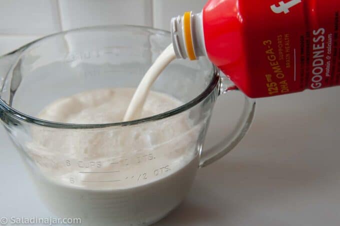 pouring ultra-filtered milk into a pyrex pitcher