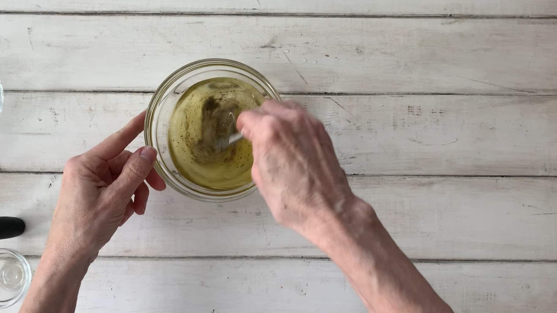 Whisking salad dressing together.