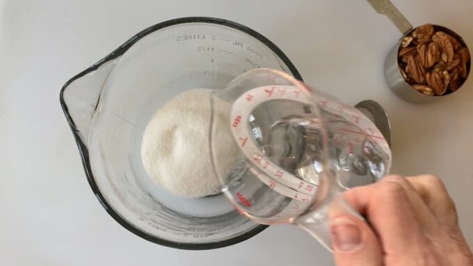 mixing water and sugar in a microwave-safe bowl