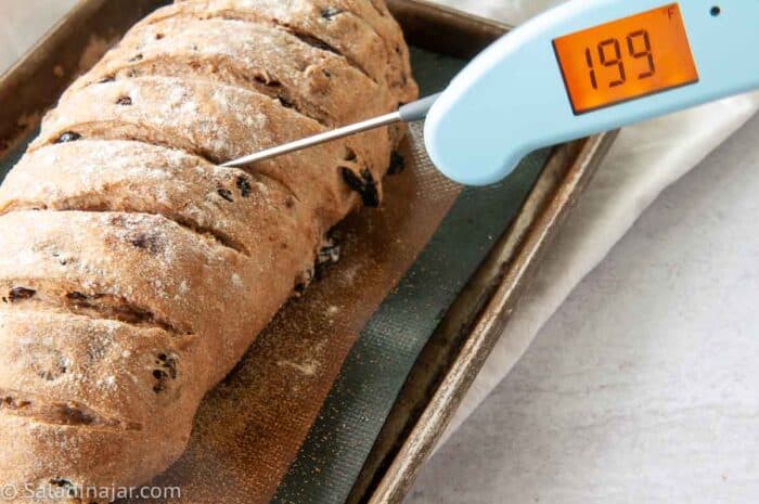 checking doneness of loaf with a quick-read thermometer