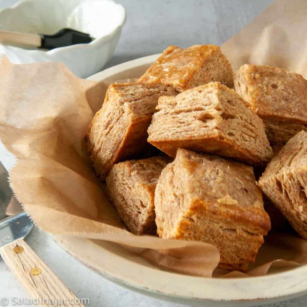 Whole Wheat Flaky Whey Biscuits with Honey Butter Glaze in a bowl ready to eat