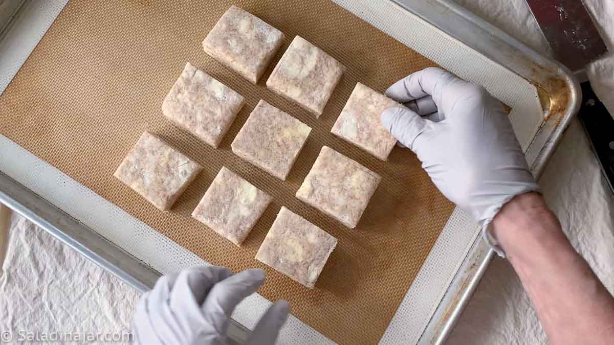 Placing biscuits on the sheet pan