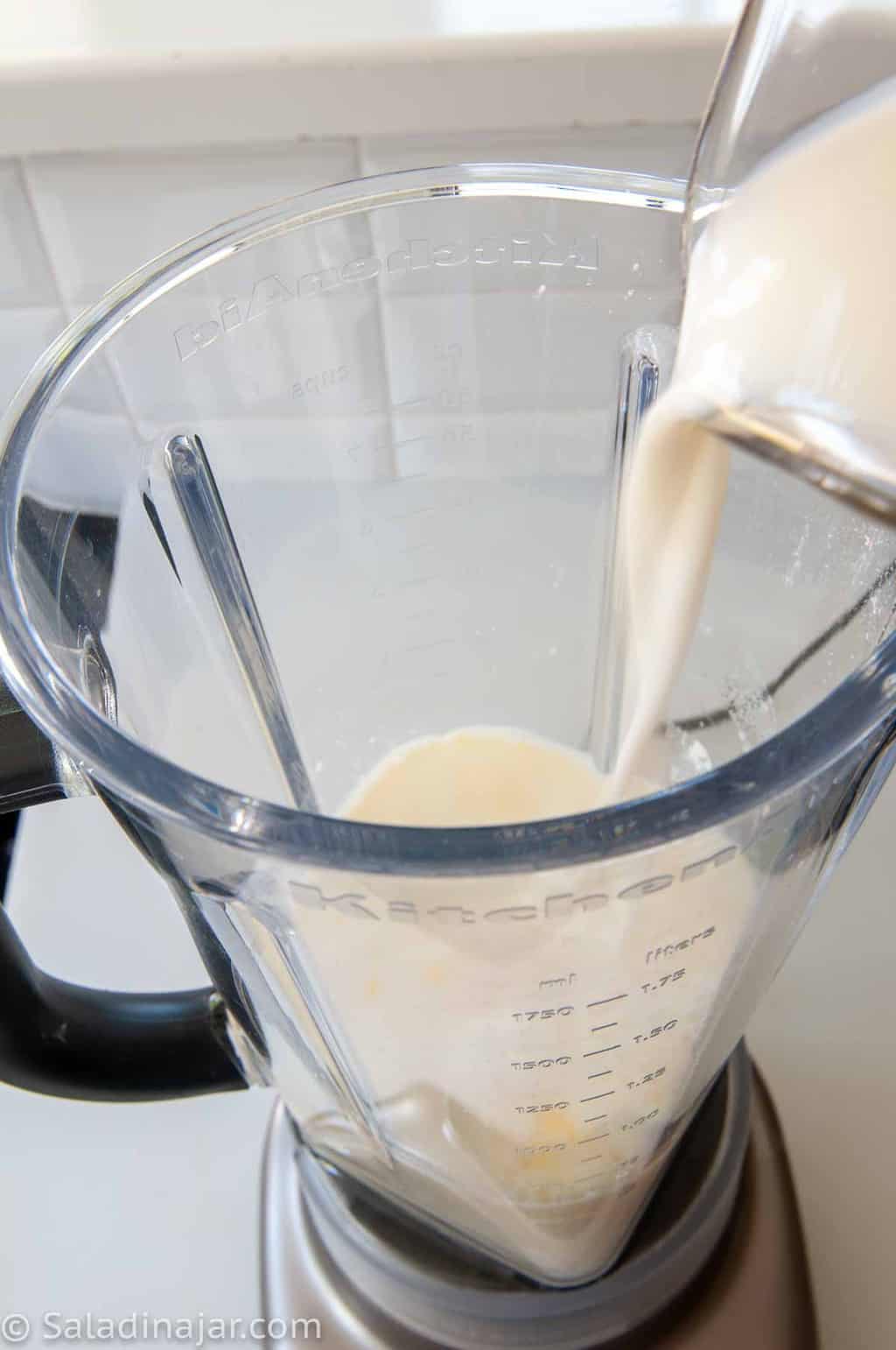 pouring ingredients for microwave pastry cream into a blender.