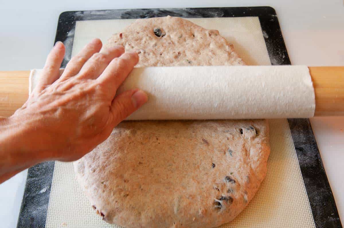 Rolling out dough with a rolling pin.