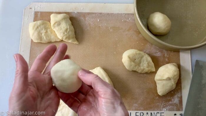 showing how to form each piece of dough into a ball with your fingers