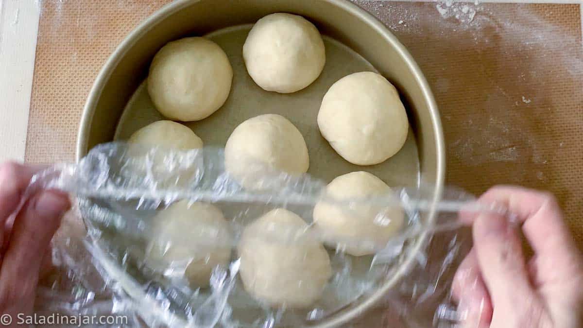 covering dough balls with a cheap shower cap